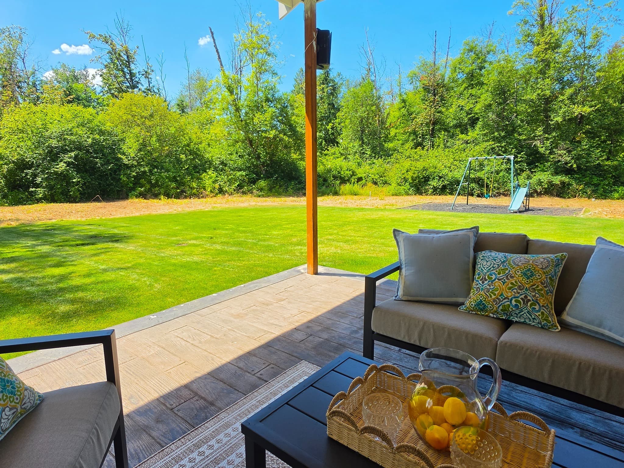 Covered patio overlooking the summer lawn